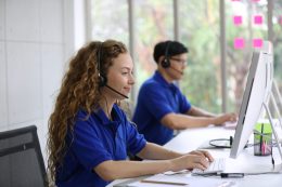 smiling-woman-in-headset-working-in-call-center-of-2023-11-27-05-33-26-utc-scaled.jpg